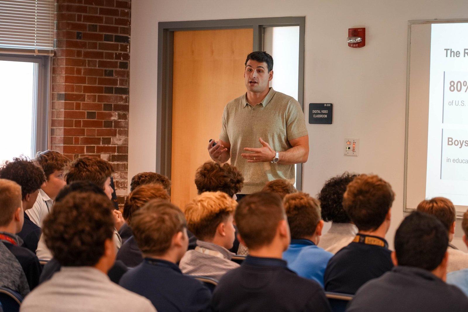 Korab Idrizi speaking to a group of students