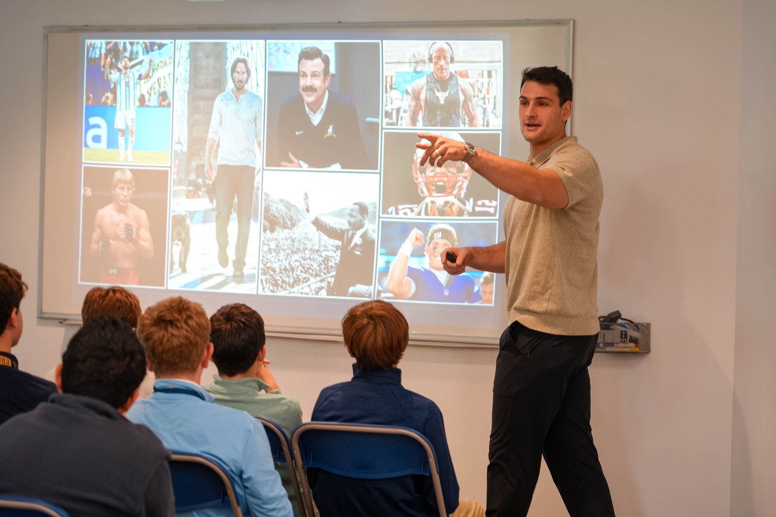 Korab Idrizi presenting about sports and performance to a classroom