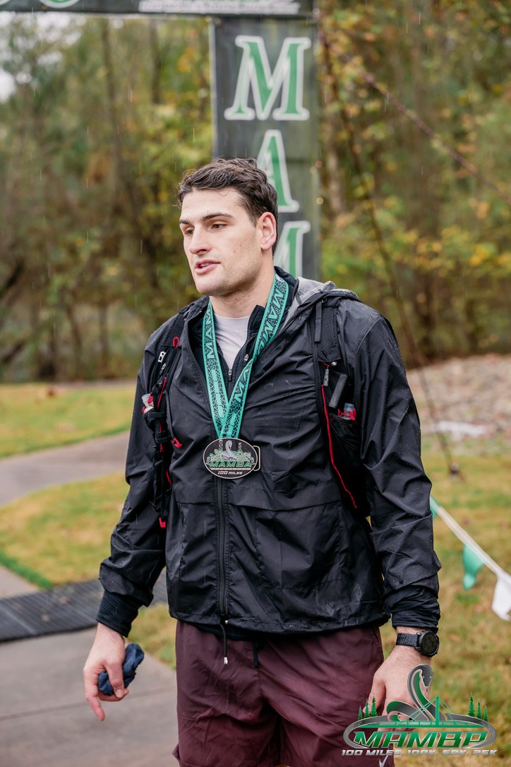 Korab Idrizi wearing his Mamba 100 finisher medal